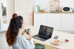 Virtual assistant drinking coffee on a video conference call with a client